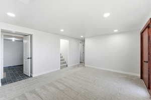 Unfurnished bedroom featuring light carpet and recessed lighting