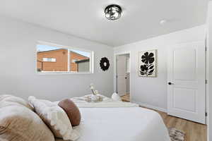 Bedroom featuring light wood-style flooring and baseboards