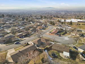Aerial view of property's location with a mountainous background and nearby suburban area