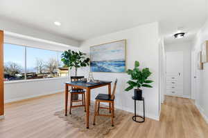 Dining space featuring light wood finished floors and an office area