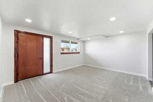 Unfurnished bedroom with light carpet and recessed lighting