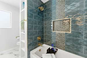 Bathroom featuring bathing tub / shower combination and toilet