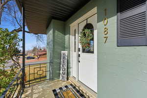 Doorway to property with covered porch