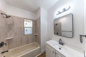 Bathroom with vanity and bathing tub / shower combination