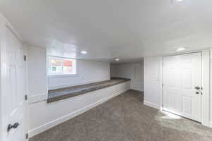 Below grade area with carpet flooring and recessed lighting