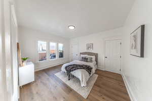 Bedroom with wood finished floors and baseboards