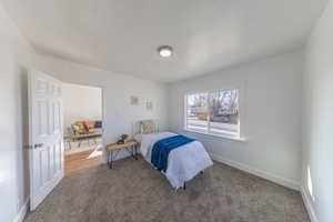 Bedroom featuring carpet flooring and baseboards