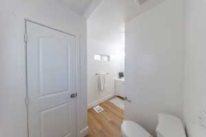 Half bath featuring light wood finished floors and vanity