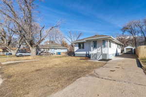 View of front of property with an outbuilding, concrete driveway, and a detached garage