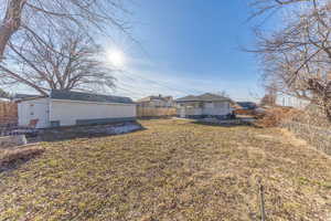 Fenced backyard with an outbuilding and a patio