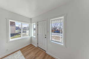 Foyer entrance with baseboards and light wood-style flooring