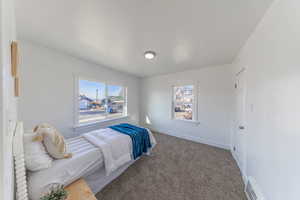 Bedroom featuring carpet floors and baseboards