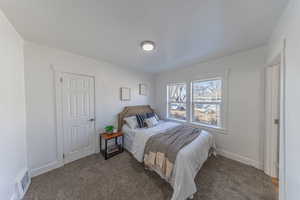 Bedroom featuring carpet and baseboards