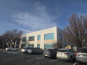 View of property featuring uncovered parking