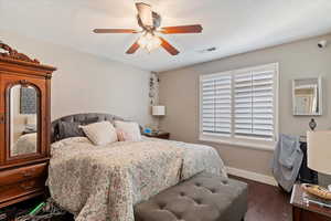 Bedroom featuring dark wood finished floors and a ceiling fan