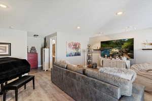 Living area with wood finished floors, a textured ceiling, and recessed lighting