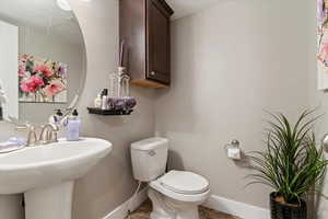 Bathroom featuring toilet and baseboards