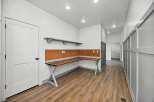 Unfurnished office with dark wood-style floors and recessed lighting