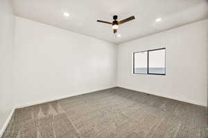 Unfurnished room featuring a ceiling fan, carpet flooring, and recessed lighting