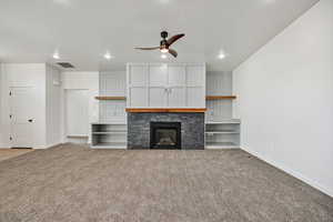 Unfurnished living room with a glass covered fireplace, ceiling fan, light carpet, and recessed lighting