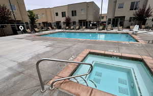 Community pool featuring a patio area and a hot tub