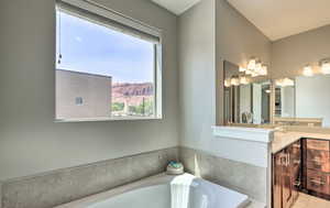 Bathroom with vanity, a garden tub, and a mountain view
