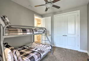 Bedroom featuring carpet, a closet, and a ceiling fan
