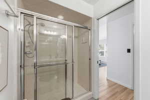 Bathroom featuring a stall shower and light wood-style flooring