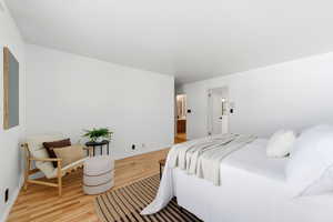 Bedroom featuring wood finished floors and baseboards
