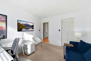 Carpeted office space with baseboards