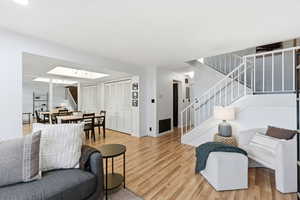 Living area featuring stairway and wood finished floors