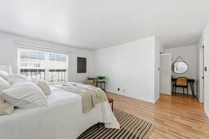 Bedroom featuring light wood-style flooring and baseboards