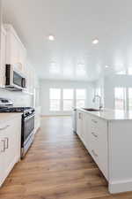 WHITE CABINETS, QUARTZ COUNTERTOPS & STAINLESS STEELO GAS STOVE! (PICTURE OF PREVIOUS BUILT HOME-COLORS AND MATERIALS MAY VARY)