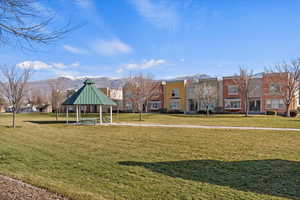 View of property's community with a yard, a mountain view, and a gazebo