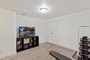 Exercise room with carpet flooring and a textured ceiling