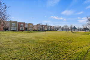 View of property's community featuring a yard