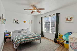 Bedroom with wood finished floors and ceiling fan