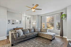 Living area with wood finished floors and a ceiling fan