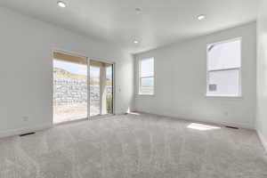 Spare room with light colored carpet and recessed lighting