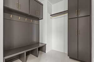 Mudroom featuring baseboards and light tile patterned floors