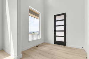 Foyer featuring light wood-style flooring and baseboards