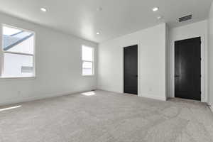Unfurnished bedroom featuring light colored carpet and recessed lighting