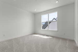 Unfurnished room featuring carpet and recessed lighting