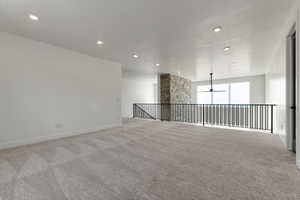 Empty room with ceiling fan, light carpet, and recessed lighting