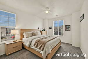 Bedroom featuring dark colored carpet and ceiling fan
