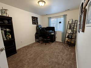 Office area featuring carpet floors and baseboards