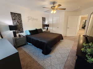 Bedroom with light colored carpet and ceiling fan