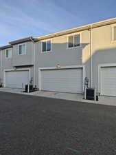 Traditional home with stucco siding and a garage