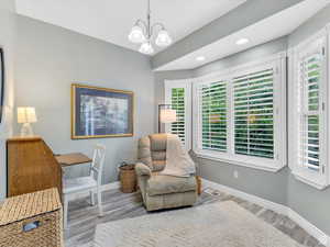 Office space featuring wood finished floors, a chandelier, and recessed lighting