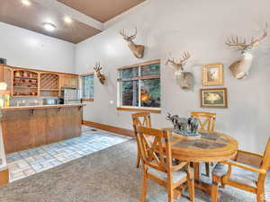 Dining area featuring baseboards and light colored carpet